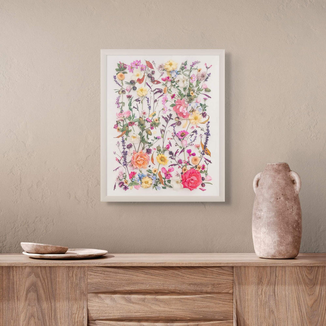 Autumn Wind hanging in white frame above chest with pottery