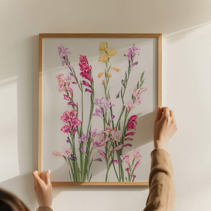 Hands holding oak framed flower art print of Gladiolus