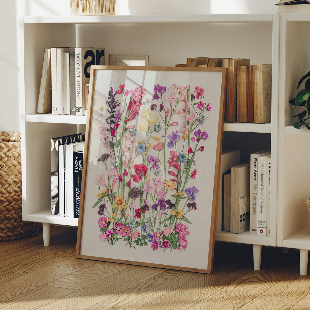 Framed flower print Poppy and Gladiolus leaning on bookshelf