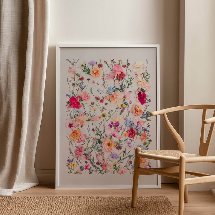 White framed The Fig and Olive Garden next to chair