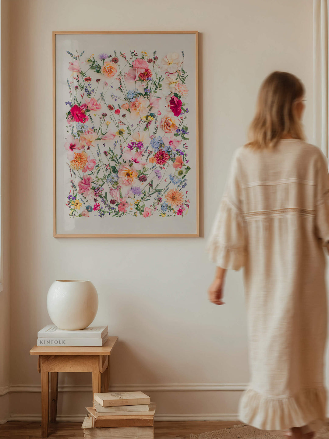 Woman walking past print The Fig and Olive Garden